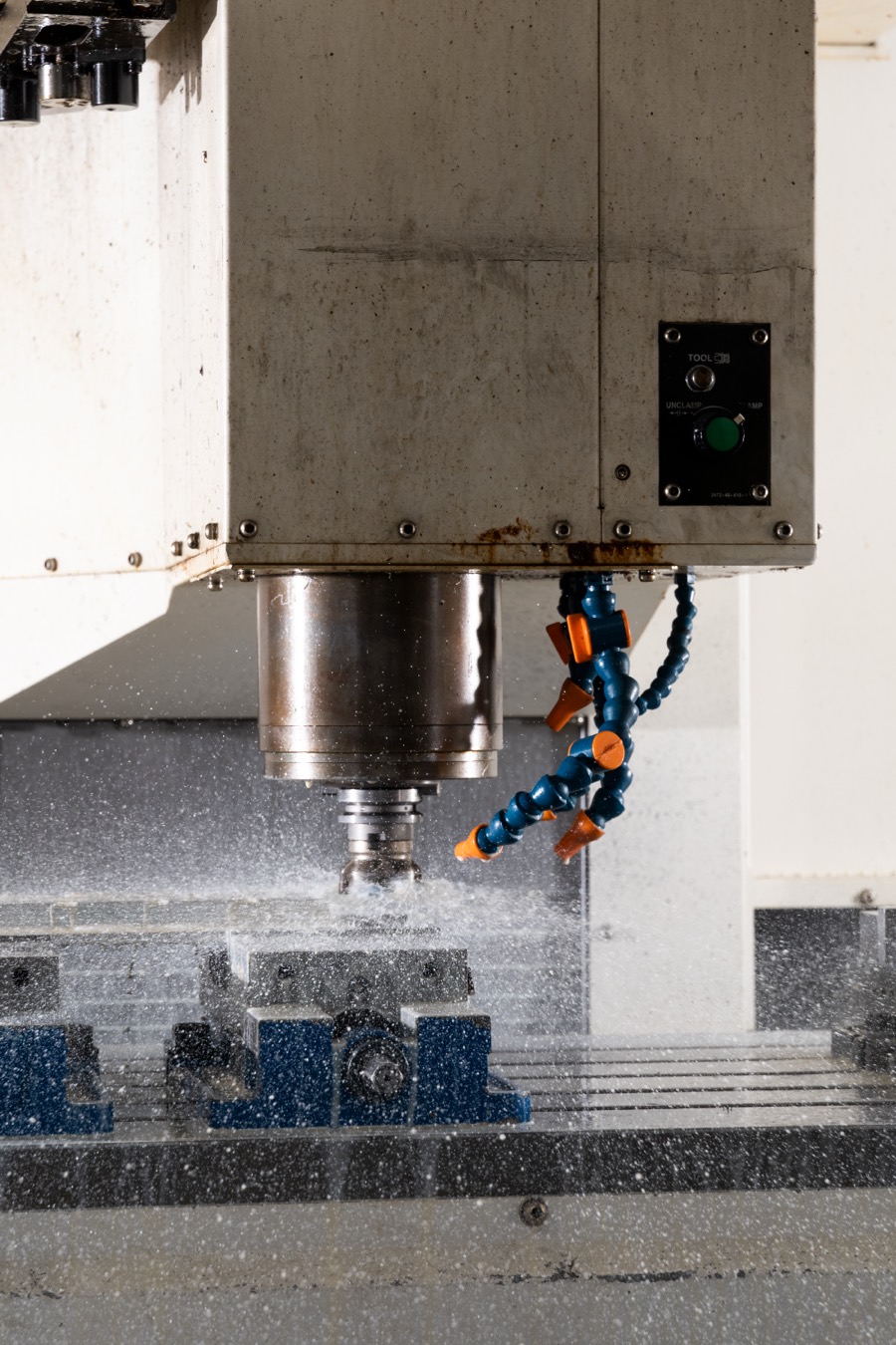 CNC mill cutting with coolant in the ACR North machine shop