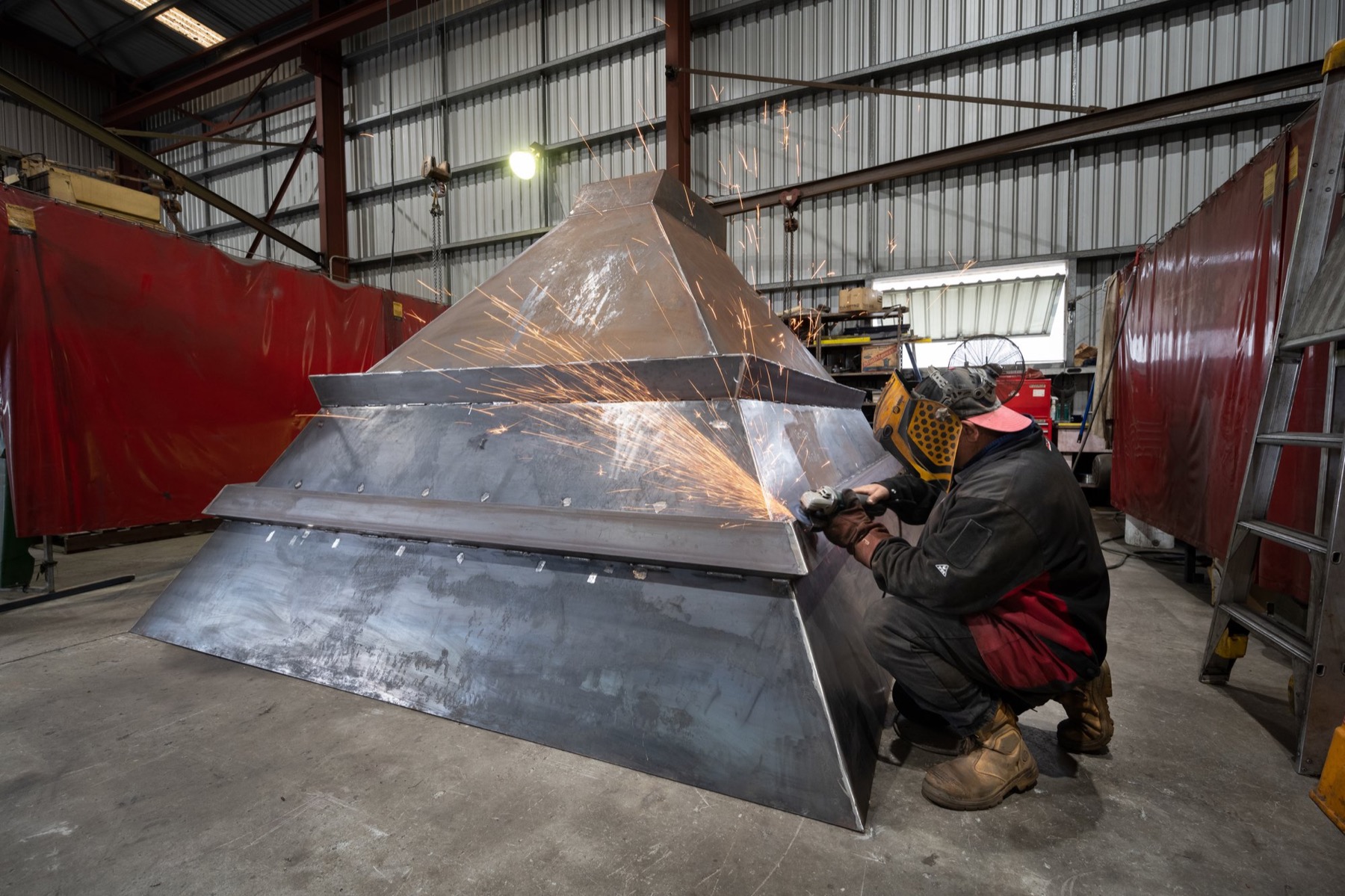 ACR North boilermaker grinding welds on a large fabricated steel hopper